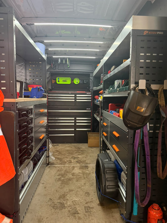 Mercedes Sprinter MWB high roof with StowPro racking: worktop and vice over service cases and drawers, shelving opposite